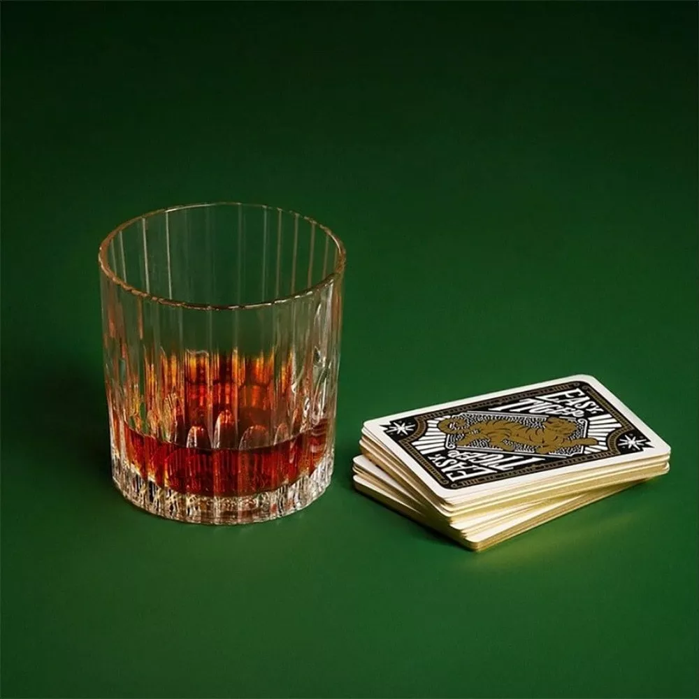 Cognac served neat next to playing cards