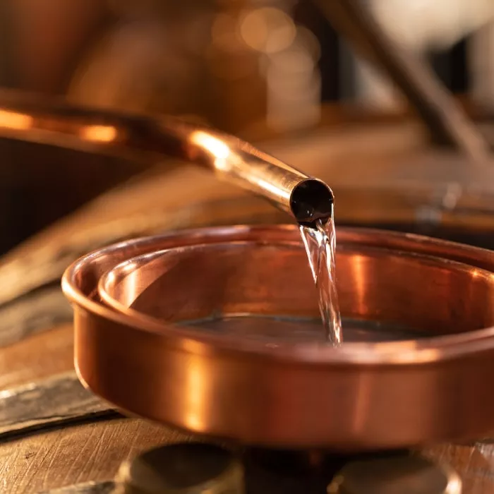 Testing cognac in a copper pan.