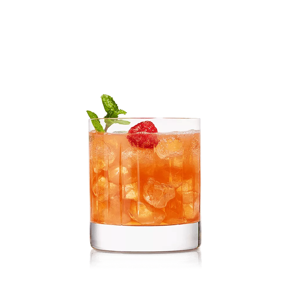 Raspberry Daisy Cocktail in a short glass garnished with mint sprigs and a raspberry.